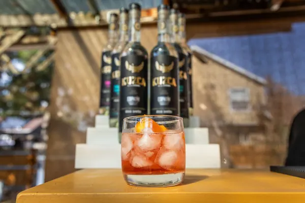 A mezcal Old Fashioned in front of KUZCA bottles